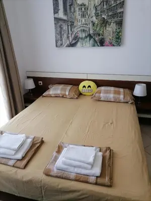 a bed with two towels on top of it at Apolon 2 in Sozopol