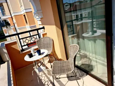 a balcony with a table and chairs on a balcony at Studio Greenn Life Beach Resort in Sozopol