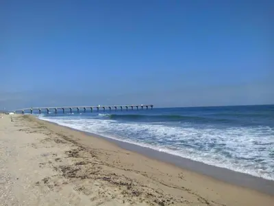 a beach with a long pier in the ocean at SRB Sadovo-Resort-Bulgaria in Sadovo