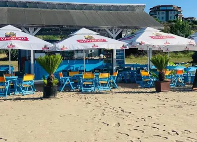 a group of chairs and umbrellas on the beach at A-33-Sea View Studio Apartment Sarafovo in Burgas City