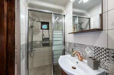 a bathroom with a sink and a shower at Villa Viara in Pchelnik