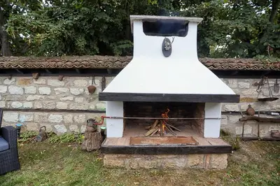a outdoor oven with a fire in a yard at Villa Viara in Pchelnik