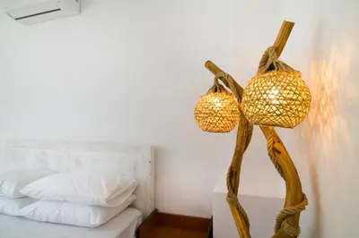 a lamp with two baskets on a table next to a bed at Апартамент BOHO CHIC Free parking in Varna City