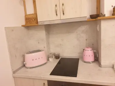 a kitchen counter with a pink toaster and a toaster at Апартамент BOHO CHIC Free parking in Varna City