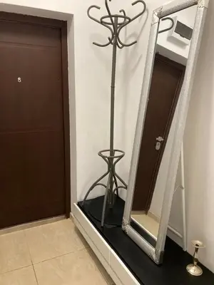 a mirror with a stand in front of a door at Уютная квартира - студия в Старом Поморие, Болгария in Pomorie