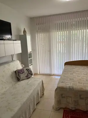 a bedroom with a bed and a large window at Уютная квартира - студия в Старом Поморие, Болгария in Pomorie