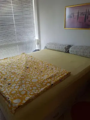 a bedroom with a bed with a blanket on it at Ravda Sun Sea Ressort 2 in Ravda