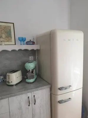 a kitchen with a mixer next to a refrigerator at Апартамент BOHO CHIC 2 Free parking in Varna City