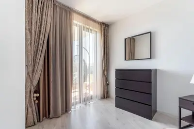 a bedroom with a dresser and a large window at Premium complex Millennium 2 - Family apartment & Spa in Sveti Vlas