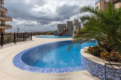 a swimming pool on the roof of a building with a slide at Premium complex Millennium 2 - Family apartment & Spa in Sveti Vlas