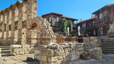 a stone wall in front of a building at Sun Wave Apartament in Sveti Vlas