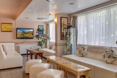 a living room with white furniture and a large window at Paraiso Beach - All Inclusive in Obzor
