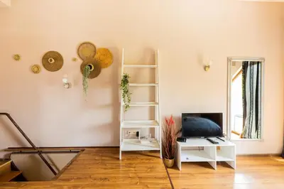 a living room with white furniture and a fireplace at Quiet Maisonette \u30e1 Free Parking in Varna City