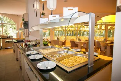 a buffet in a restaurant with a tray of food at Touristic Complex Hacienda Beach Apartments Sozopol in Sozopol