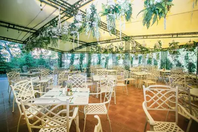 a dining room with white tables and chairs at Touristic Complex Hacienda Beach Apartments Sozopol in Sozopol