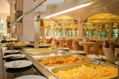 a buffet line with food in a restaurant at Touristic Complex Hacienda Beach Apartments Sozopol in Sozopol