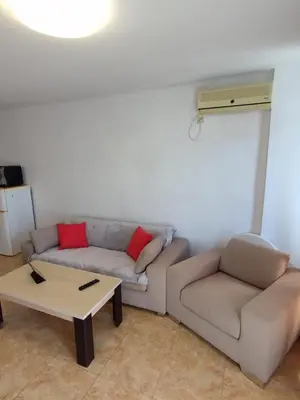 a living room with a couch and a coffee table at Midia Grand Resort, Terrassen Paradies Apartment in Aheloy