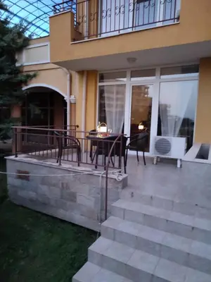 a patio with a table and chairs on a house at Midia Grand Resort, Terrassen Paradies Apartment in Aheloy
