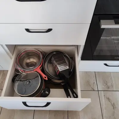 a drawer filled with pots and pans and utensils at апартамент на брега на морето Бургас - Сарафово in Burgas City