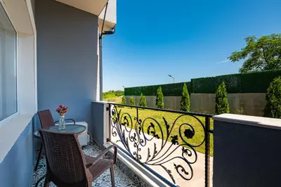 a balcony with a table and chairs on a balcony at La Mansión in Lozenets