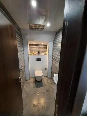 a bathroom with a toilet and a sink at The Penthouse in Varna City