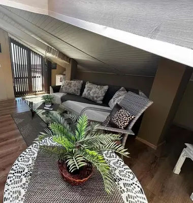 a living room with a couch and a table at DAMARIS in Sozopol