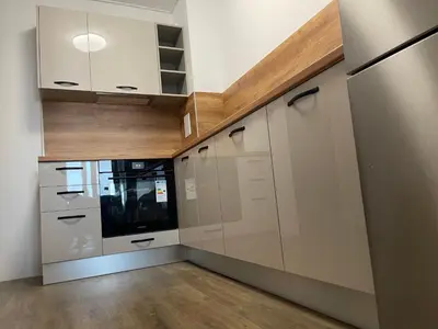 a kitchen with white cabinets and a counter top at DeTY's Apartment in Burgas City