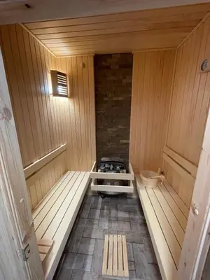an inside view of a sauna with a stove at DeTY's Apartment in Burgas City