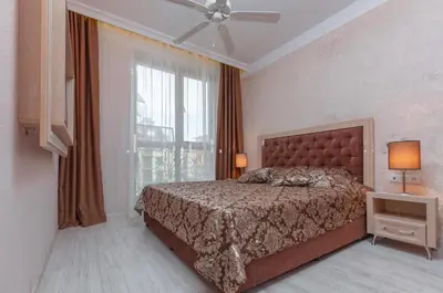 a bedroom with a bed and a large window at Monte Carlo in Sunny Beach