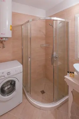 a shower in a bathroom with a washing machine at Monte Carlo in Sunny Beach