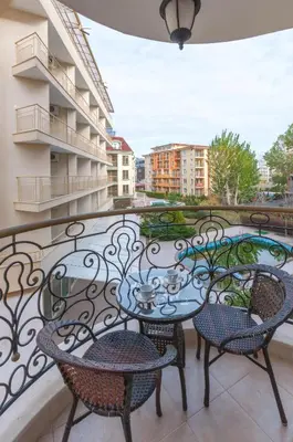 a balcony with two tables and chairs on a balcony at Monte Carlo in Sunny Beach