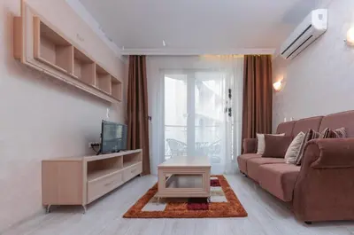 a living room with a couch and a tv at Monte Carlo in Sunny Beach