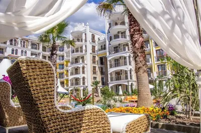 a table and chairs in front of a large building at Monte Carlo in Sunny Beach