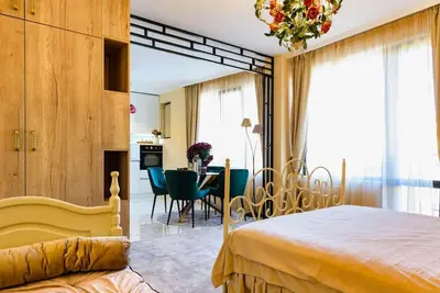 a bedroom with a bed and a dining room at CASA ARTA in Burgas City