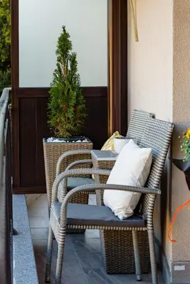 a wicker chair with a pillow on a porch at CASA ARTA in Burgas City