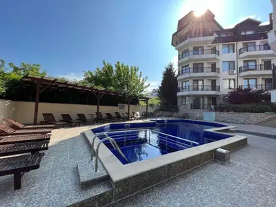 a swimming pool in front of a building at Бяла Виста Бийч Апартментс B - Byala Vista Beach Apartments B in Byala