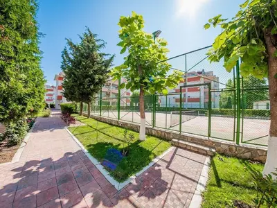 a park with a fence and trees and buildings at studio, sunny fort, sunny beach in Sunny Beach