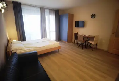 a hotel room with a bed and a table and chairs at studio, sunny fort, sunny beach in Sunny Beach
