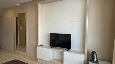a living room with a flat screen tv on a wall at PARADISO 'В' 107 Private Cozy Studio NESSEBAR in Nesebar