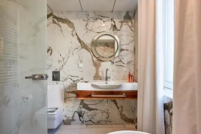 a bathroom with a sink and a mirror at Premium Luxury SeaSide Apartment in Burgas City