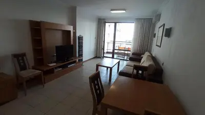 a living room with a couch and a tv and a table at СПА Апартаменти за ГОСТИ Затворен комплекс ЕМЕРАЛД in Ravda