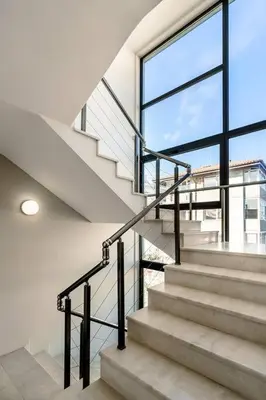 a staircase in a house with a window at ЛУКСОЗНА ТРИЕТАЖНА КЪЩА в центъра на Приморско in Primorsko