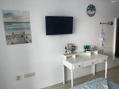 a white desk with a tv on a white wall at PARADISO 'B' 108 Private Cozy Room NESSEBAR in Nesebar