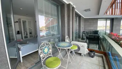a balcony with a table and chairs on a building at PARADISO 'B' 108 Private Cozy Room NESSEBAR in Nesebar