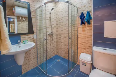 a bathroom with a shower and a toilet and a sink at Admiral Plaza Holiday Apartments in Sunny Beach