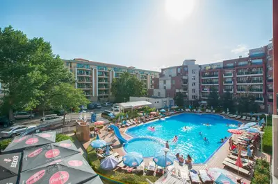 an overhead view of a swimming pool with umbrellas at Admiral Plaza Holiday Apartments in Sunny Beach