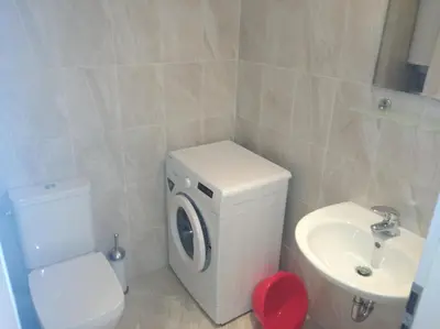 a bathroom with a white toilet and a sink at Niya Apartments Kavaci Sozopol in Sozopol