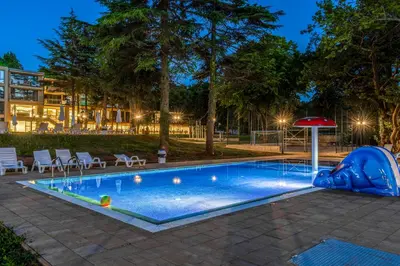 a swimming pool with an inflatable at Queen Nelly Park in Kiten