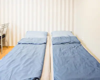 two beds in a corner of a room at DOWNTOWN - BEST Price Small Apartment in Burgas City