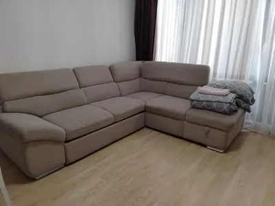 a brown couch sitting in a living room at Apartments Sarafovo in Burgas City